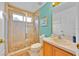 Bathroom features a glass shower, tile floors and wood vanity at 303 Plumoso Loop, Davenport, FL 33897