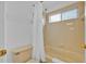 Bright bathroom with a tiled shower and a white shower curtain at 303 Plumoso Loop, Davenport, FL 33897
