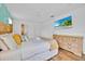 Well-lit bedroom with a large bed, coordinating furniture, and a wall-mounted TV for relaxing evenings at 303 Plumoso Loop, Davenport, FL 33897