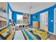 Bright bedroom with two twin beds and a cartoon wallpaper at 303 Plumoso Loop, Davenport, FL 33897