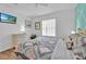Relaxing bedroom with a queen bed, flat screen TV and wood-look flooring at 303 Plumoso Loop, Davenport, FL 33897