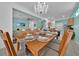 Elegant dining room with chandelier and seating, open to living and kitchen areas at 303 Plumoso Loop, Davenport, FL 33897