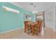 Bright dining room with modern chandelier, seating for six, and serene views at 303 Plumoso Loop, Davenport, FL 33897