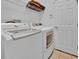 Convenient laundry room featuring modern washer and dryer units at 303 Plumoso Loop, Davenport, FL 33897
