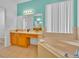 Large main bathroom featuring soaking tub, spacious vanity, and ample natural light at 303 Plumoso Loop, Davenport, FL 33897