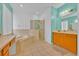 Spacious main bathroom with a soaking tub, walk-in shower, and double vanity at 303 Plumoso Loop, Davenport, FL 33897