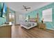 Inviting main bedroom with wood floors and stylish accent wall at 303 Plumoso Loop, Davenport, FL 33897
