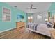 Serene main bedroom with wood floors, pool views, and a ceiling fan at 303 Plumoso Loop, Davenport, FL 33897