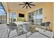 Covered patio with a stylish dining set, ideal for outdoor entertaining and relaxation at 303 Plumoso Loop, Davenport, FL 33897