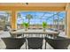 Covered patio offering serene views, featuring a dining set and tranquil ambiance at 303 Plumoso Loop, Davenport, FL 33897