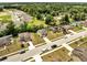 Aerial view of a neighborhood featuring many two-story homes, green lawns, and tree-lined streets at 320 Southern Winds Blvd, Deland, FL 32720