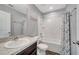 Bathroom features a large white vanity, shower, and tub with wood-look flooring, creating a clean and inviting space at 320 Southern Winds Blvd, Deland, FL 32720