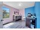 Colorful bedroom with pink and blue walls, a crib, and ample natural light, perfect for a young Gathering at 320 Southern Winds Blvd, Deland, FL 32720