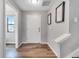 Entryway features wood-look floors, white door, neutral walls, and staircase to the right at 320 Southern Winds Blvd, Deland, FL 32720