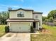 Two-story home featuring an attached two-car garage, neutral color scheme and well-maintained landscaping at 320 Southern Winds Blvd, Deland, FL 32720