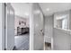 Hallway featuring an open doorway to a room with soft pink walls and a crib, creating a warm, inviting space at 320 Southern Winds Blvd, Deland, FL 32720