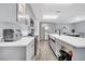 Spacious kitchen showcasing sleek gray cabinets, stainless steel appliances, and a large island at 320 Southern Winds Blvd, Deland, FL 32720