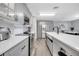 Modern kitchen featuring gray cabinets, stainless steel appliances, and a functional kitchen island at 320 Southern Winds Blvd, Deland, FL 32720