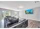 Modern living room featuring a gray sectional and wood-look flooring for a contemporary aesthetic at 320 Southern Winds Blvd, Deland, FL 32720