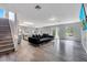 Open concept living room featuring durable flooring, neutral walls, large sectional sofa, and stairs at 320 Southern Winds Blvd, Deland, FL 32720