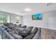 Living room features durable flooring, neutral walls, large sectional sofa, window and tv at 320 Southern Winds Blvd, Deland, FL 32720