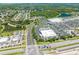 This aerial view captures a bustling shopping center with a variety of stores and ample parking, nestled in a vibrant community at 3203 Herons Point Cir, Kissimmee, FL 34741