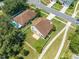 Aerial view of a home with a spacious backyard featuring grass and a stone patio at 3203 Herons Point Cir, Kissimmee, FL 34741