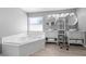 Bright bathroom featuring a soaking tub, dual vessel sinks, and modern vanities at 3203 Herons Point Cir, Kissimmee, FL 34741