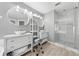 Bright bathroom featuring double sinks, modern fixtures, and a glass-enclosed shower at 3203 Herons Point Cir, Kissimmee, FL 34741