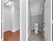 Bathroom featuring a toilet and linen storage with access to a closet on hardwood floors at 3203 Herons Point Cir, Kissimmee, FL 34741