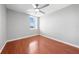 Bright bedroom features a ceiling fan, hardwood floors, and a window providing natural light at 3203 Herons Point Cir, Kissimmee, FL 34741