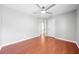 Bedroom features hardwood floors, neutral walls, a ceiling fan, and a doorway to another room at 3203 Herons Point Cir, Kissimmee, FL 34741