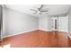 Spacious bedroom with hardwood floors, a ceiling fan, and an en-suite bathroom at 3203 Herons Point Cir, Kissimmee, FL 34741