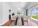 Dining room featuring a glass table, seating for eight, and sliding glass doors at 3203 Herons Point Cir, Kissimmee, FL 34741