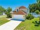 Inviting two-story home featuring a two-car garage and lush landscaping at 3203 Herons Point Cir, Kissimmee, FL 34741