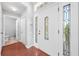 Bright foyer featuring wood floors, a decorative front door, and white trim at 3203 Herons Point Cir, Kissimmee, FL 34741
