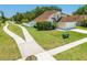 This home features a well-maintained lawn and convenient driveway, enhancing curb appeal and accessibility at 3203 Herons Point Cir, Kissimmee, FL 34741