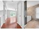 Hallway view showing hardwood floors, paint, and a bathroom with a large mirror and vanity at 3203 Herons Point Cir, Kissimmee, FL 34741