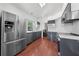 Bright kitchen featuring stainless steel appliances and sleek gray cabinetry at 3203 Herons Point Cir, Kissimmee, FL 34741