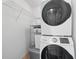 A laundry room featuring a stacked washer and dryer, wire shelving, and storage at 3203 Herons Point Cir, Kissimmee, FL 34741
