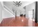 Living room with hardwood floors, stairs to the left and a seating area visible with two leather armchairs at 3203 Herons Point Cir, Kissimmee, FL 34741