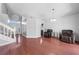 Living area showcasing hardwood floors, front door access and seating area with two armchairs at 3203 Herons Point Cir, Kissimmee, FL 34741