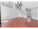 Bright living room featuring hardwood floors, staircase, and soaring ceilings with decorative fan and light fixture at 3203 Herons Point Cir, Kissimmee, FL 34741