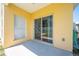 A covered patio with a sliding glass door overlooks the backyard at 3203 Herons Point Cir, Kissimmee, FL 34741