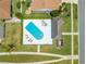Aerial view of a community pool with lounge chairs and a nearby building at 3203 Herons Point Cir, Kissimmee, FL 34741