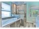 Bright bathroom showcasing a large soaking tub and elegant tiled walk-in shower at 330 Chiquita Ct, Kissimmee, FL 34758