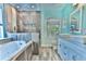 Luxurious bathroom featuring a soaking tub, walk-in shower, and dual vanities at 330 Chiquita Ct, Kissimmee, FL 34758