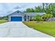 Charming single-story home featuring a well-manicured lawn and a bright blue two-car garage door at 330 Chiquita Ct, Kissimmee, FL 34758