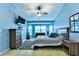 Cozy bedroom with a ceiling fan, tiled floors, and bright blue walls at 330 Chiquita Ct, Kissimmee, FL 34758