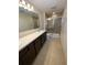 Bathroom with double vanity, granite countertop, and glass shower at 4855 Coral Castle Dr, Kissimmee, FL 34746